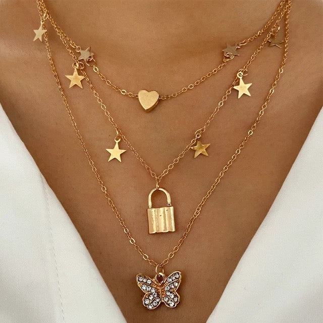 Ladies multilayered gold chain , ladies chain with stars ,  padlock , butterfly and heart pendants , ladies gift jewelry chains
